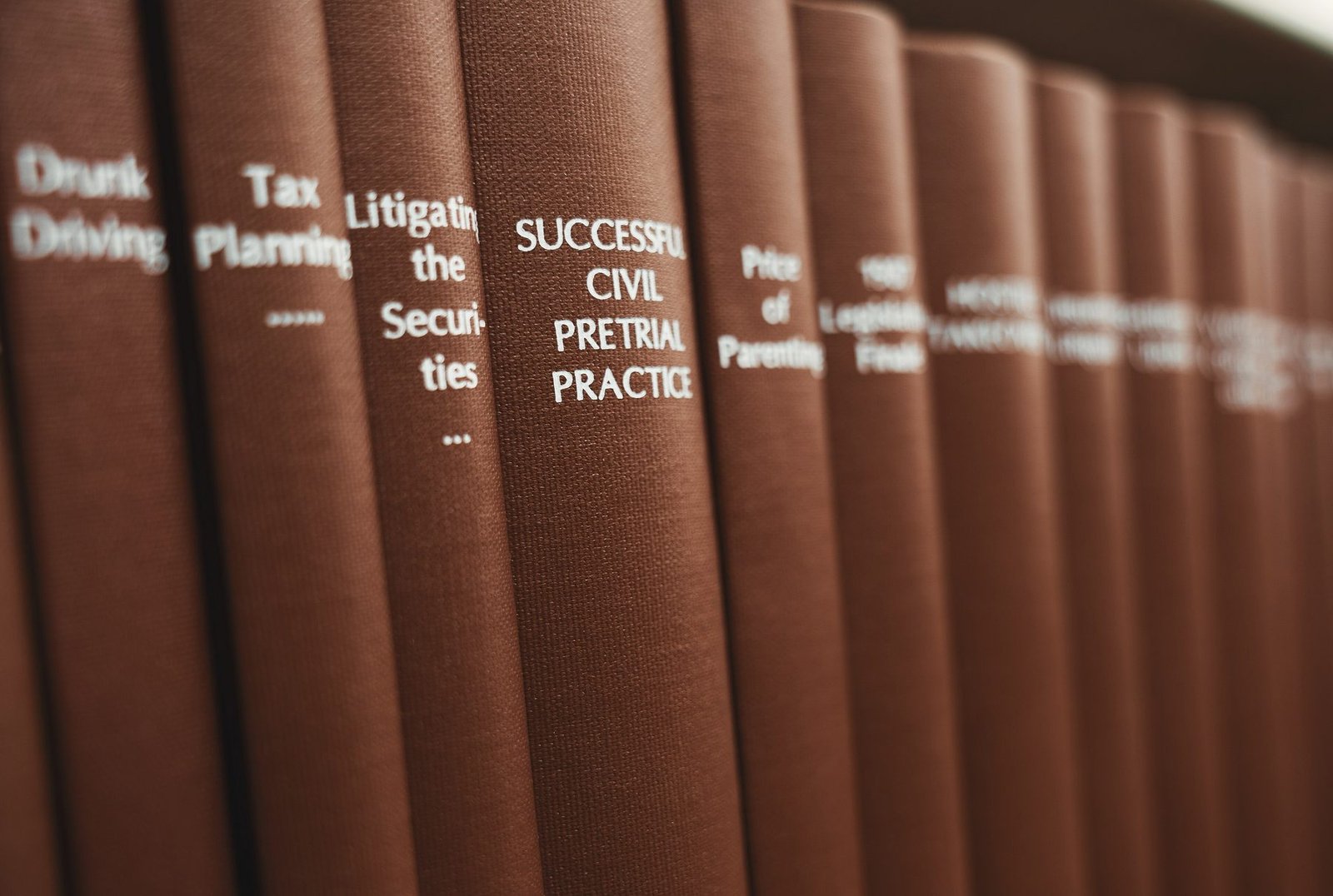 Red law book spines including a volume on civil pretrial practice